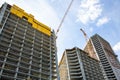 Modern urban buildings under construction with a crane and blue sky Royalty Free Stock Photo