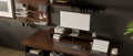 Modern urban dark loft workspace with PC computer and tablet mockup on dark wood table