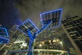 Modern urban street neon illumination with solar photovoltaic panels for power supply of streetlights and surveillance