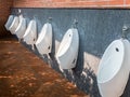 Modern urinals row. Royalty Free Stock Photo