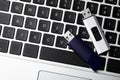 Modern usb flash drives on laptop keyboard, flat lay Royalty Free Stock Photo