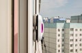 A modern vacuum robot window washer washes glass in an apartment on a balcony. View outside from the street. Safety from