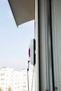 A modern vacuum robot window washer washes glass in an apartment on a balcony. View outside from the street. Safety from