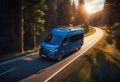 modern van traveling in nature along a country road, on a journey to adventure and freedom Royalty Free Stock Photo