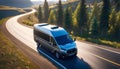 modern van traveling in nature along a country road, on a journey to adventure and freedom Royalty Free Stock Photo