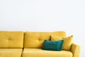 Velvet mustard sofa with pillows on white background