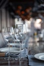 Modern veranda restaurant interior, banquet setting, glasses, plates Royalty Free Stock Photo