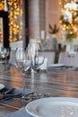 Modern veranda restaurant interior, banquet setting, glasses, plates Royalty Free Stock Photo