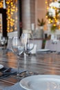 Modern veranda restaurant interior, banquet setting, glasses, plates