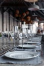 Modern veranda restaurant interior, banquet setting, glasses, plates