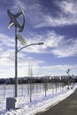 Modern vertical wind turbine and solar panel produce renewable energy