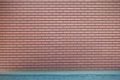 Modern vibrant red brick wall and pavement as a background image Royalty Free Stock Photo