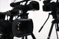 Modern video camera indoors, focus on lens. Professional media equipment for broadcasting event Royalty Free Stock Photo