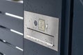 A modern videophone with a letterbox and a wireless card reader, mounted in panel fence in anthracite color, visible wicket, it ra Royalty Free Stock Photo