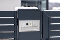 A modern videophone with a letterbox and a wireless card reader, mounted in panel fence in anthracite color, visible wicket, it ra Royalty Free Stock Photo