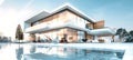 A modern villa with a glass facade, large windows, and a swimming pool Royalty Free Stock Photo
