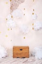 Modern vintage interior of children`s room with an old wooden chest on the background of a textured wall with clouds. Children`s p