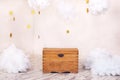 Modern vintage interior of children`s room with an old wooden chest on the background of a textured wall with clouds. Children`s p