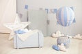 Modern vintage room interior for children with a wooden chest of drawers and a balloon with clouds on a white wall background with Royalty Free Stock Photo