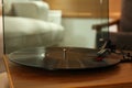 Modern vinyl record player with disc on table indoors, closeup Royalty Free Stock Photo