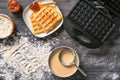 Modern waffle maker with ingredients on wooden table Royalty Free Stock Photo