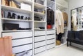 Modern walk in closet with luxury shoes and bags