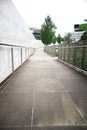 Modern Walkway Surrounded by Greenery and Architecture Royalty Free Stock Photo