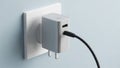 A modern wall socket with a sleek silver USB charger plugged into it Royalty Free Stock Photo