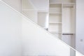 Modern wardrobe in the bedroom - before and after installation. New built-in furniture with mirror and shelves