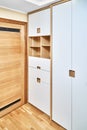 Modern wardrobe with finger pull design. Wooden wardrobe with light gray cabinet doors. Modern furniture Royalty Free Stock Photo