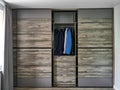 Modern wardrobe with sliding doors in room