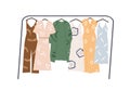 Modern wardrobe of summer clothing hanging on floor hanger rack. Casual women apparels. Collection of stylish garments