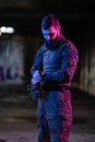 Modern warfare soldier checking navigation, time and other information on a smartwatch. Dark night black background.
