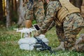 Modern Warfare Soldiers Squad are Using Drone for Scouting and Surveillance During Military Operation in the Forest. Royalty Free Stock Photo