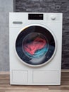 Modern washing machine against the wall. Laundry. Royalty Free Stock Photo