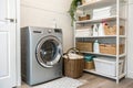 Modern washing machine with basket in laundry room Royalty Free Stock Photo