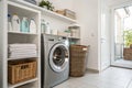 Modern washing machine with basket in laundry room Royalty Free Stock Photo