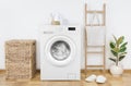 Modern washing machine with basket in laundry room interior Royalty Free Stock Photo
