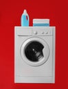 Modern washing machine with stack of towels and detergent on background. Laundry day Royalty Free Stock Photo