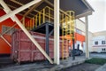 At modern waste recycling plant, process of loading sorted garbage from conveyor belt into container for further transportation b