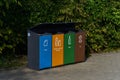 Modern waste sorting bin against the trees in the park Royalty Free Stock Photo