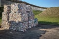 Modern waste sorting and recycling plant. Bales of dairy and drink bottles garbage in recycling plant yard prepared for shipment Royalty Free Stock Photo