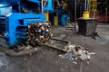 Modern waste sorting and recycling plant, hydraulic press makes Royalty Free Stock Photo