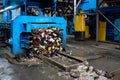 Modern waste sorting and recycling plant, hydraulic press makes wired bale from pressed PET bottles for processing and reuse of Royalty Free Stock Photo