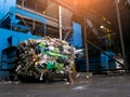 Modern waste sorting and recycling plant, hydraulic press makes wired bale from pressed PET bottles for processing and reuse of Royalty Free Stock Photo