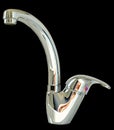 Modern water tap made in the form of a chrome-plated monoblock f Royalty Free Stock Photo