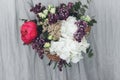 Modern wedding bouquet in hands close up. Woman in rustic dress holding beautiful peony, lilac, roses, hydrangea flowers and Royalty Free Stock Photo