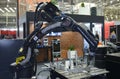 Modern welding robot Yaskawa working on stand in the exhibition hall. Industry exhibition. Kyiv, Ukraine
