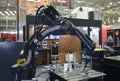 Modern welding robot Yaskawa working on stand in the exhibition hall. Industry exhibition
