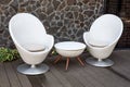 Modern white armchairs and table, modern garden furniture. Cozy space for relax in the garden. Royalty Free Stock Photo